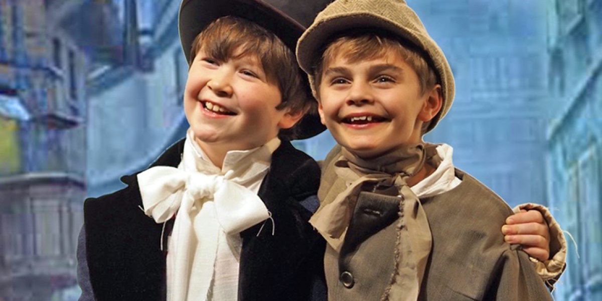 The Company Theatre presents holiday season musical favorite Oliver! from November 23 through December 16 in Norwell. Pictured are Colin Paduck as Artful Dodger of Weymouth, and Matthew O'Connor as Oliver, of Hingham. Photo by Zoe Bradford