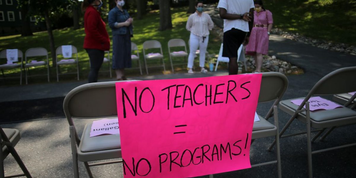 Signs protesting the layoffs greeted people outside the Heath School in Brookline.LANE TURNER/GLOBE STAFF